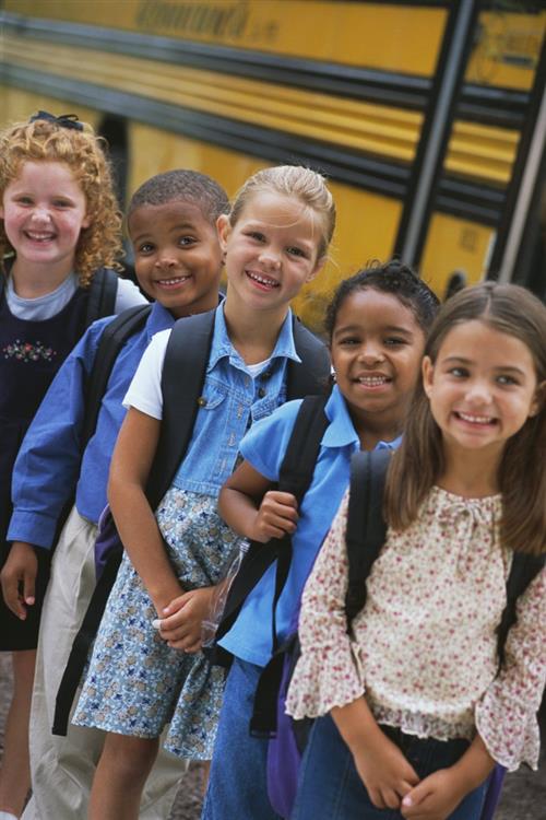 Smiling students waiting in bus line 